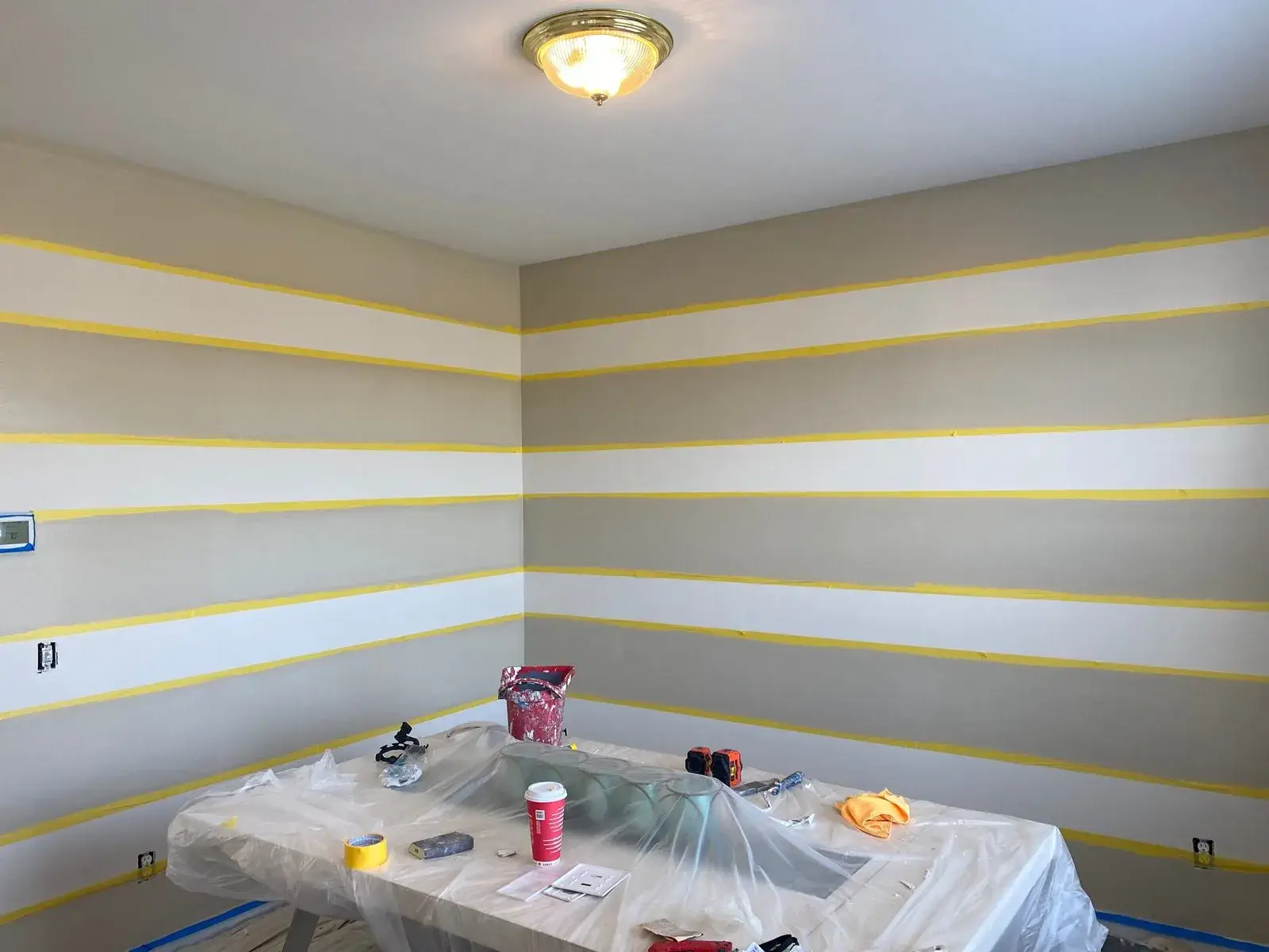In progress: staircase with black spindles, dining room and bedroom stripes, bathroom vanity