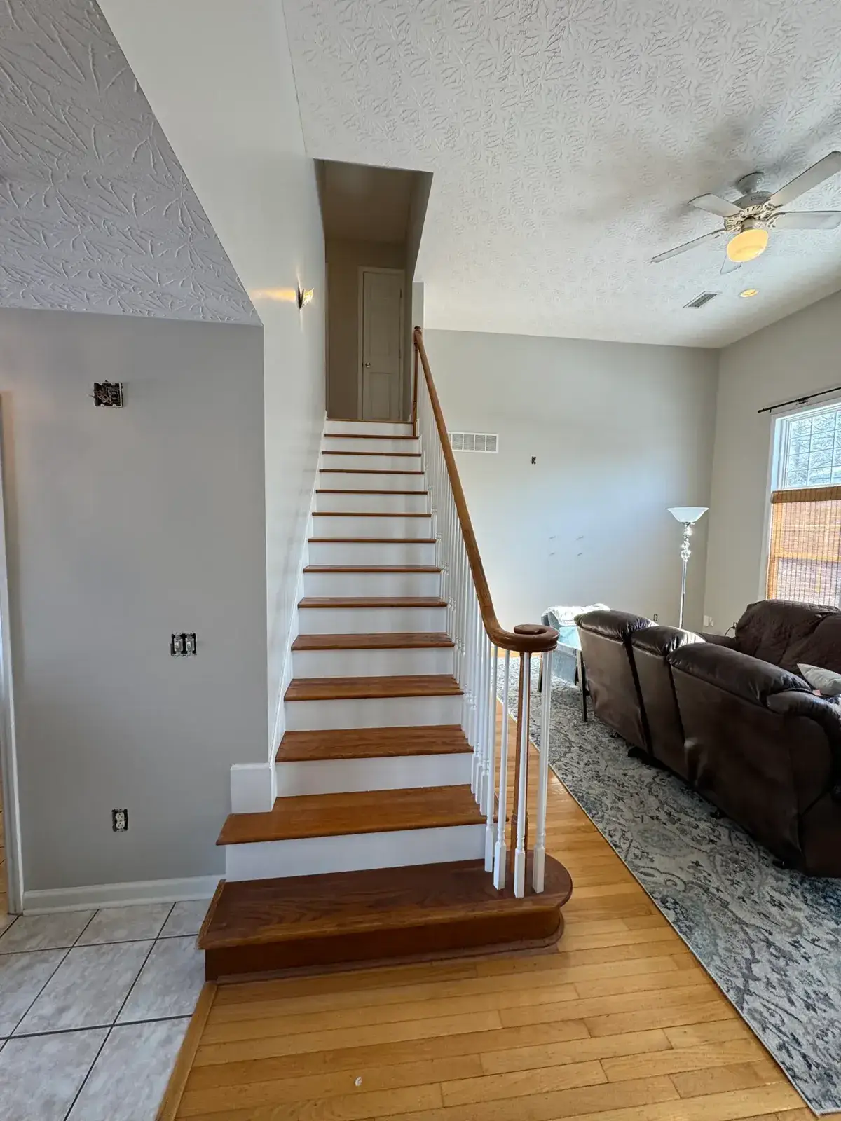 After: staircase with oak treads and white spindles