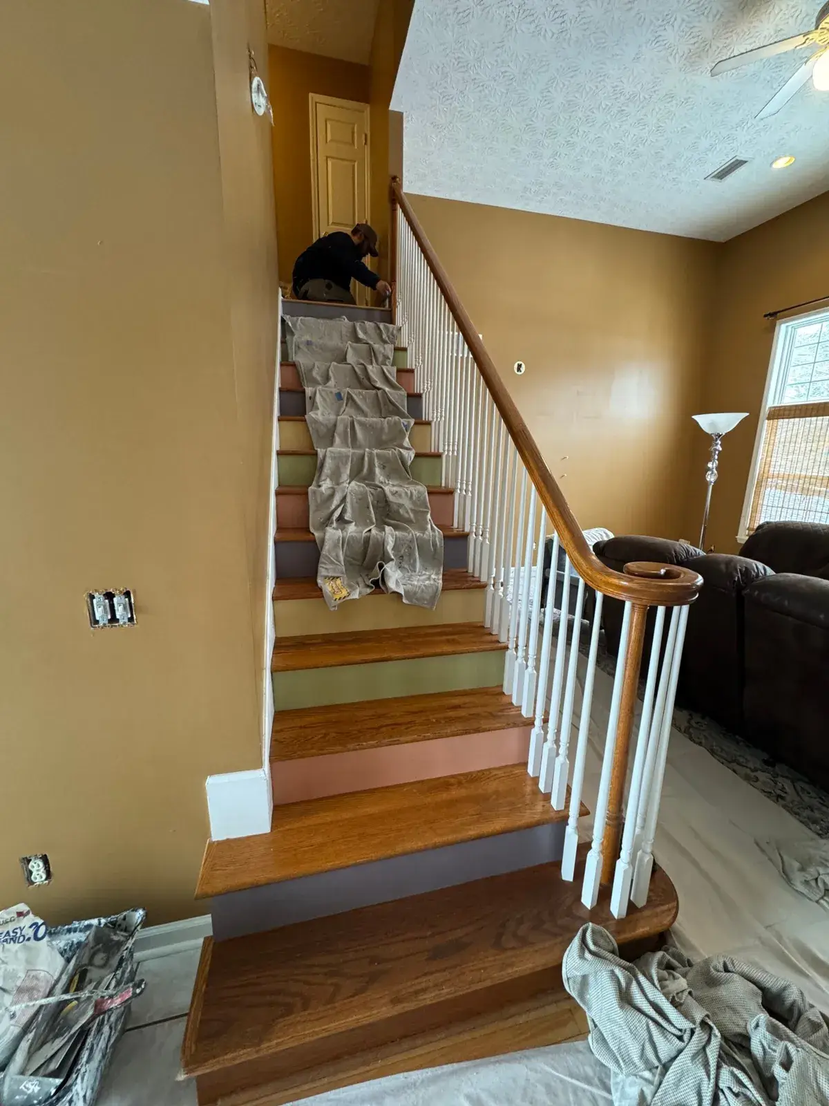 Before: staircase with oak treads and white spindles