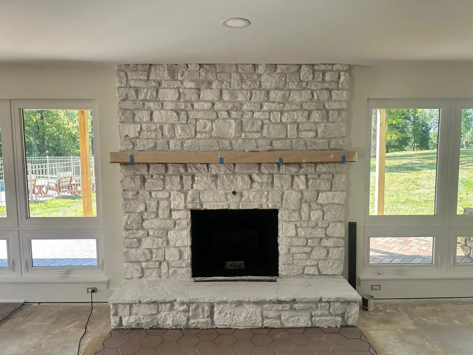 After: stone fireplace limewashed