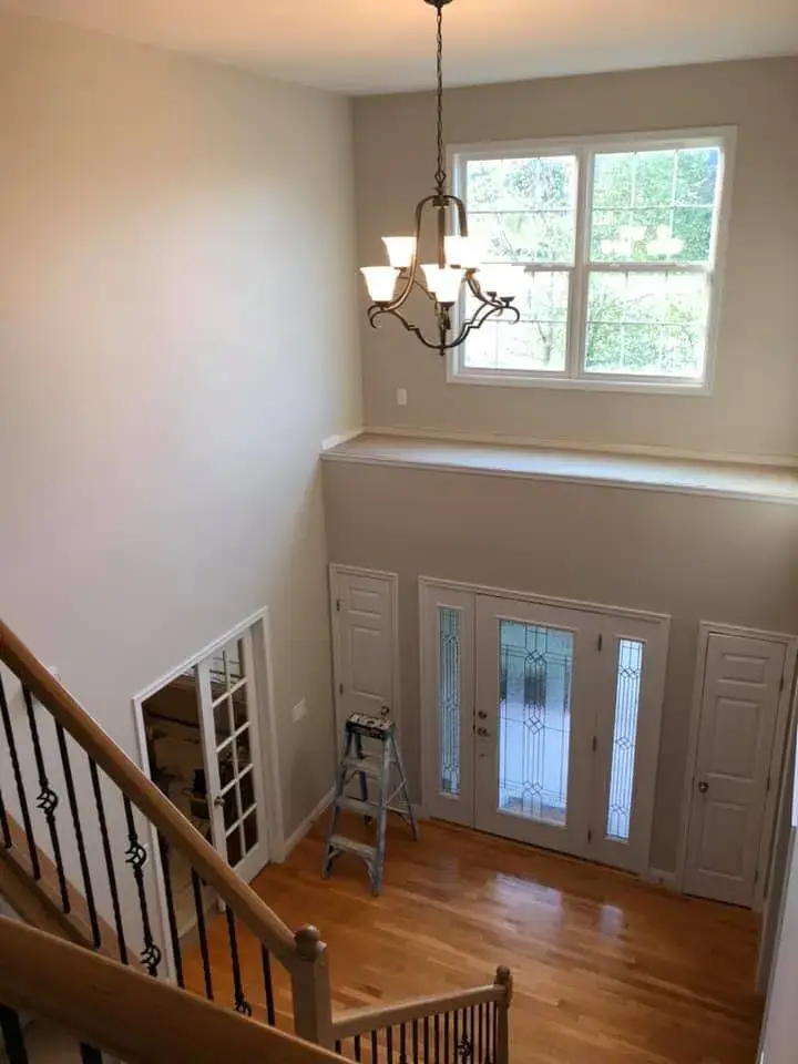 After: two-story foyer, stairwell and great room repainted; bedrooms painted beige