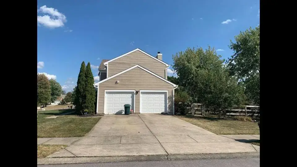 After: two-story tan siding home exterior trim