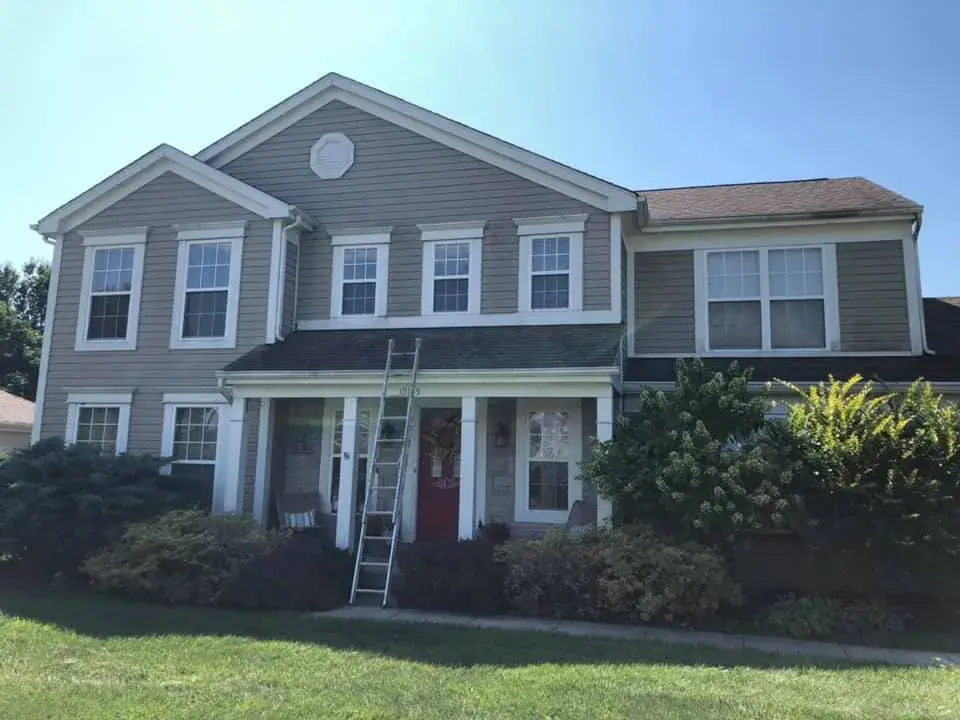Before: two-story tan siding home exterior trim