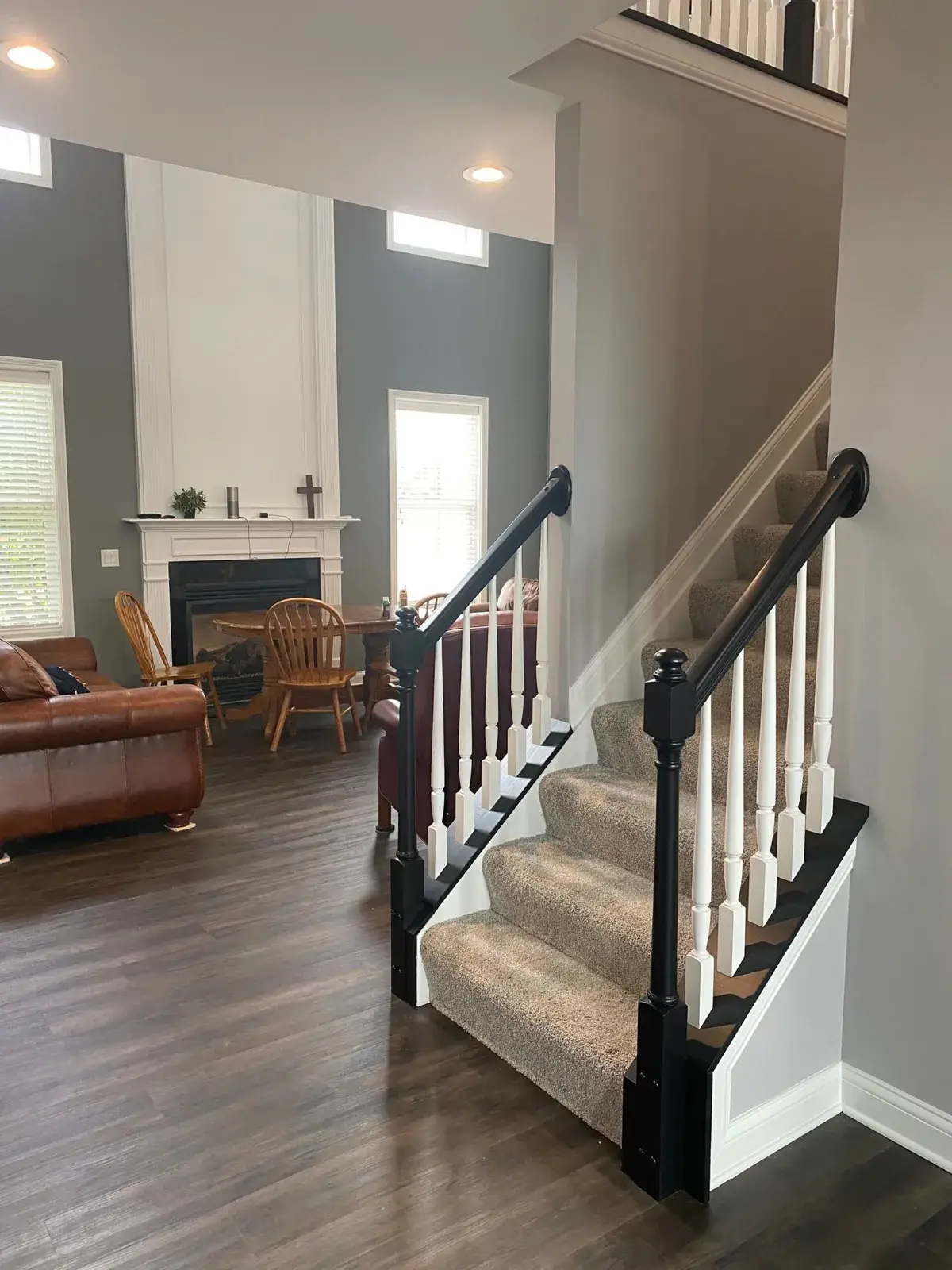 After: upstairs railing painted: black handrail, white spindles