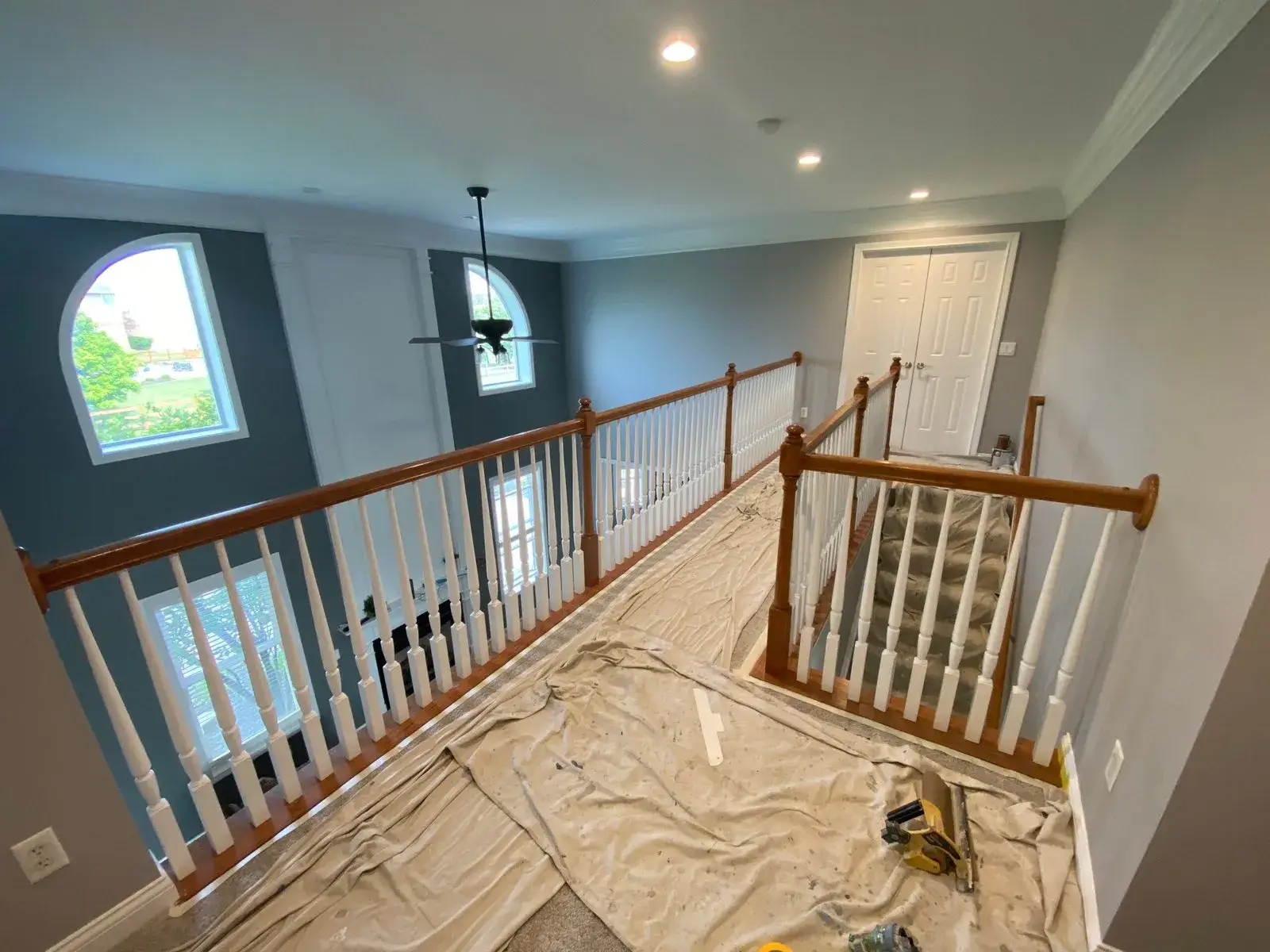Before: upstairs railing painted: black handrail, white spindles