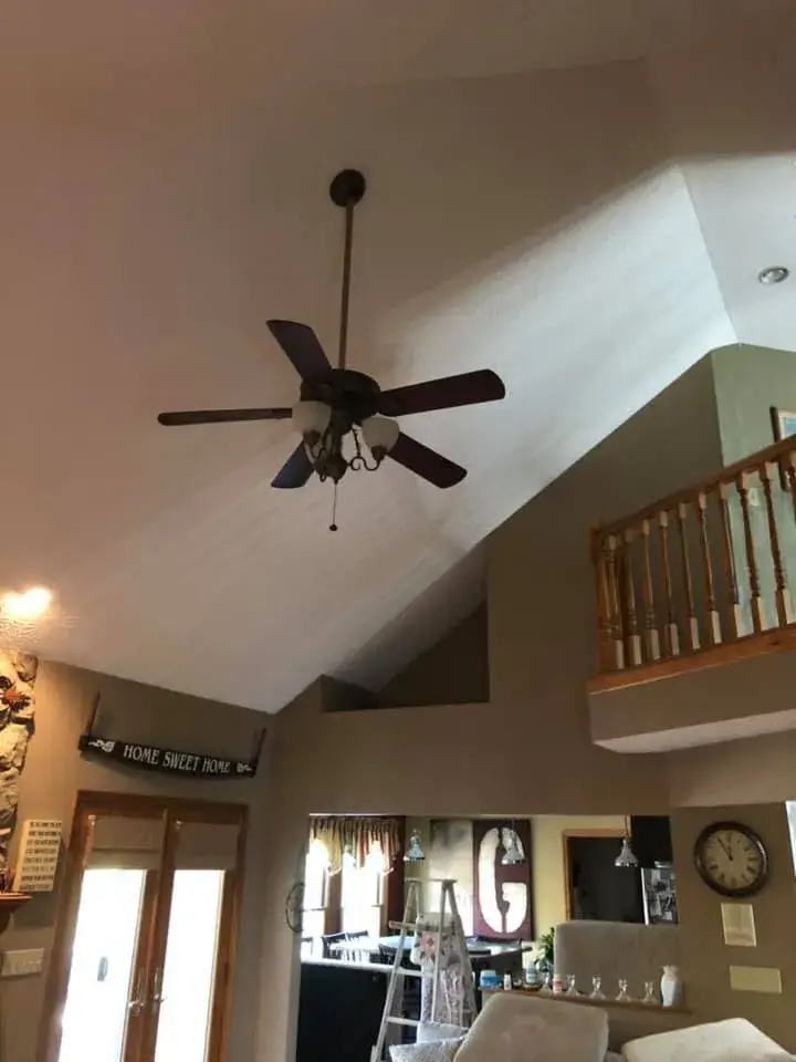 After: vaulted living room, stairwell and textured ceilings painted