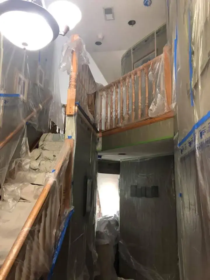 Staircase and landing covered in plastic sheeting for painting. - My Personal Painter - My Personal Painter In progress: vaulted living room, stairwell and textured ceilings painted