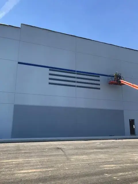 After: warehouse: tilt-up exterior walls and interior walls, columns and offices painted