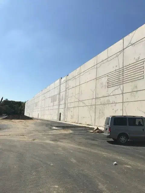 Before: warehouse: tilt-up exterior walls and interior walls, columns and offices painted