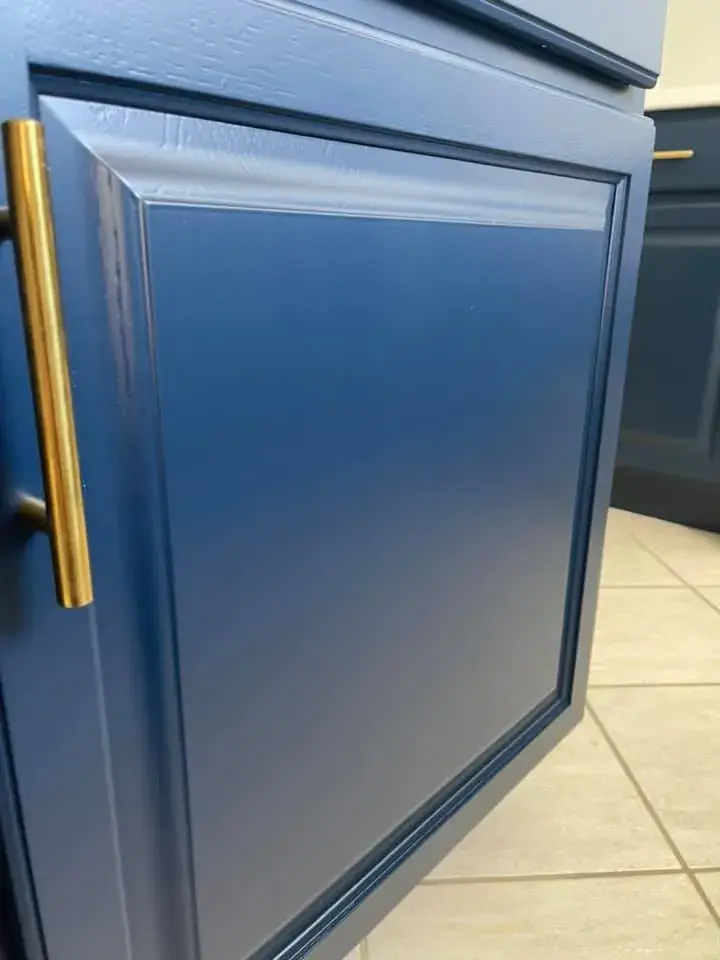 After: wood kitchen painted white with navy island