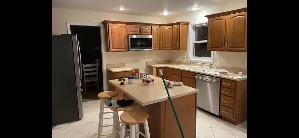 Before: wood kitchen painted white with navy island