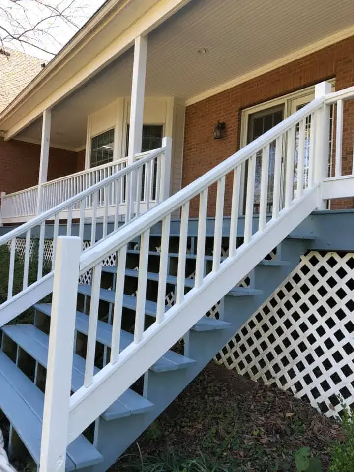 After: wraparound porch on brick Cape Cod: railings white, floor painted blue-gray