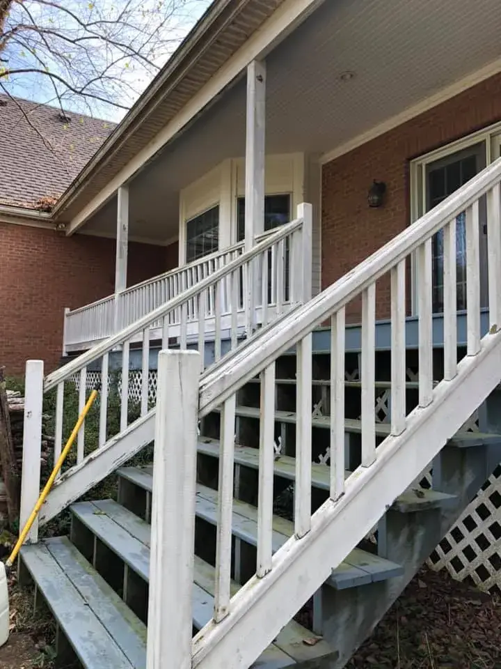 In progress: wraparound porch on brick Cape Cod: railings white, floor painted blue-gray